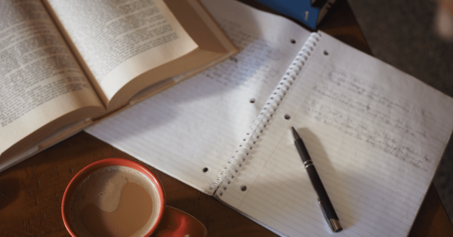 An open Latin book and notes.