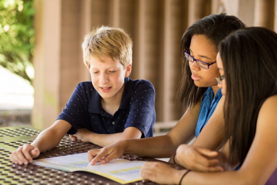 three homeschool students reading together
