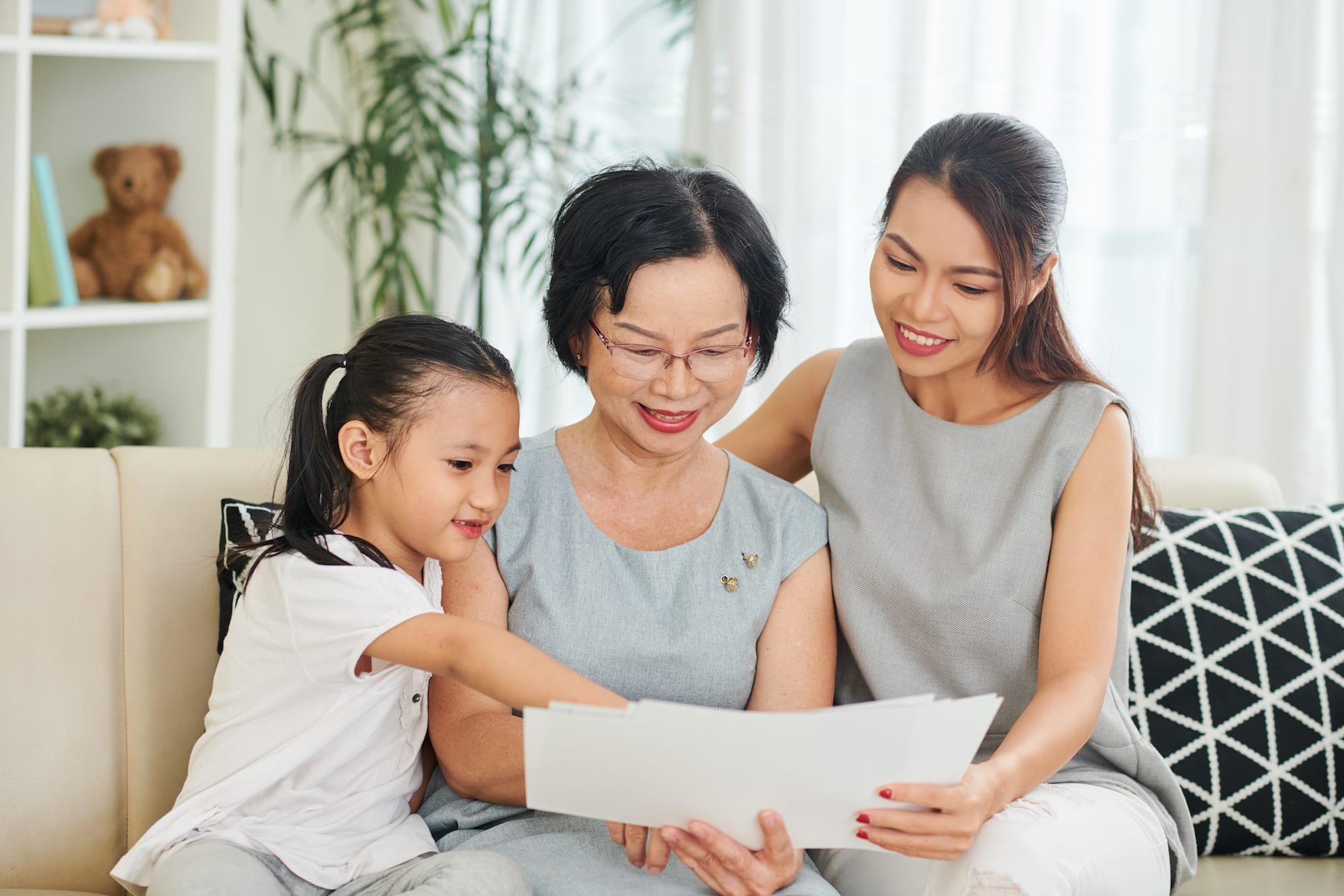 a family looking at pictures on a couch