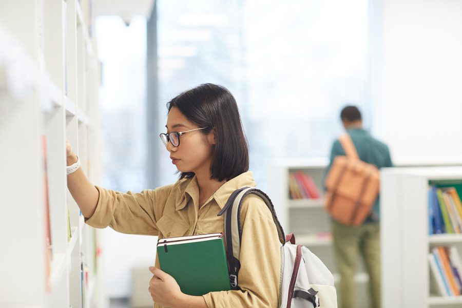 A Challenge student pins a note to the wall.
