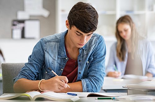 A young man focuses on his college-level coursework.