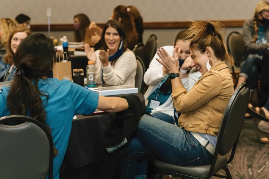 A group of laughing women at the Las Vegas Sales Orientation.