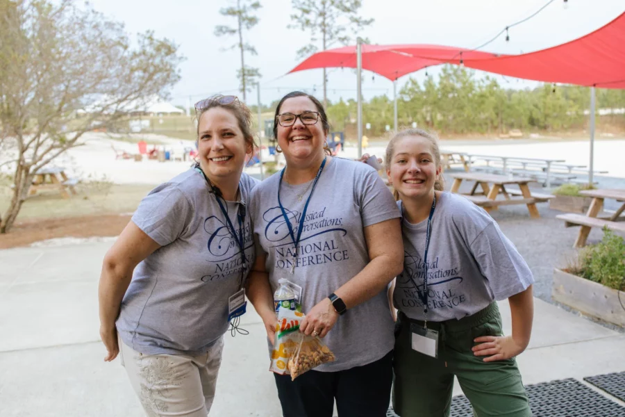 A trio of smiling women at National Conference.