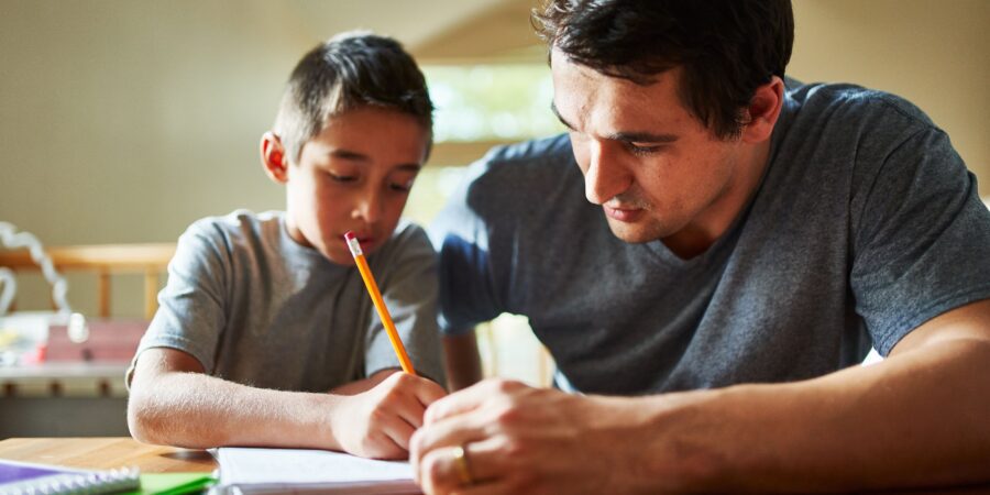 Dad and son studying together.