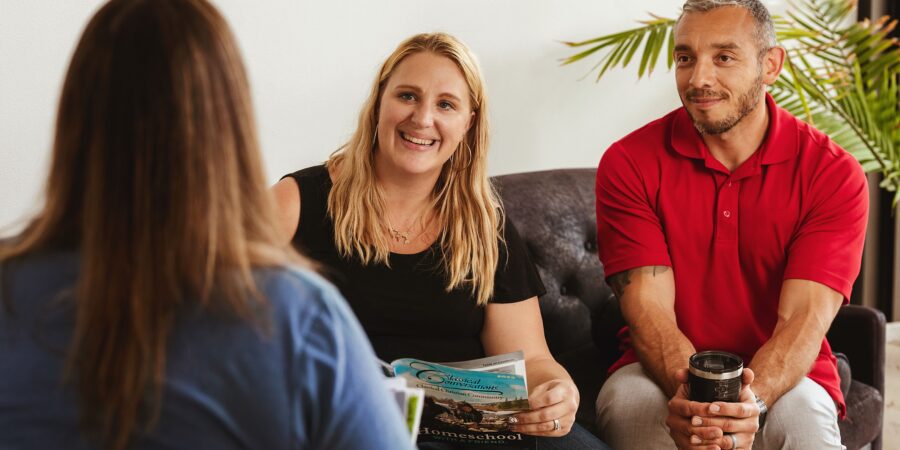 Homeschool dad and mom meeting with Classical Conversations rep.