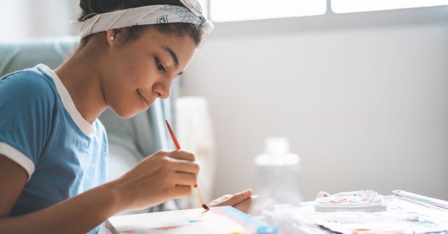 A high school homeschool student painting.
