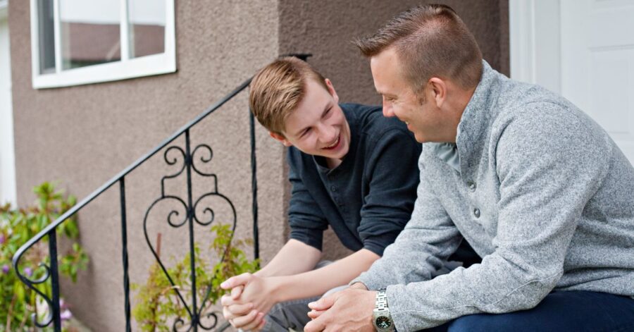 A picture of a father and son talking.