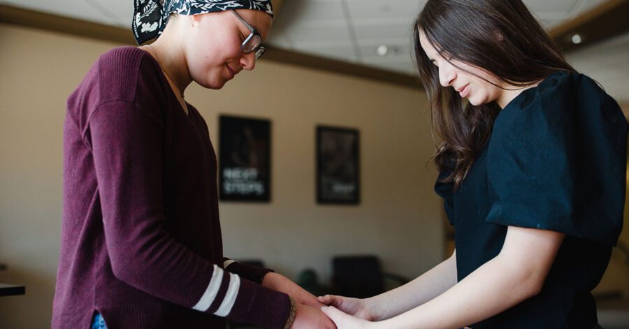 Two homeschool students praying together
