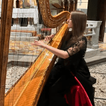 Homeschool high school student playing the harp.
