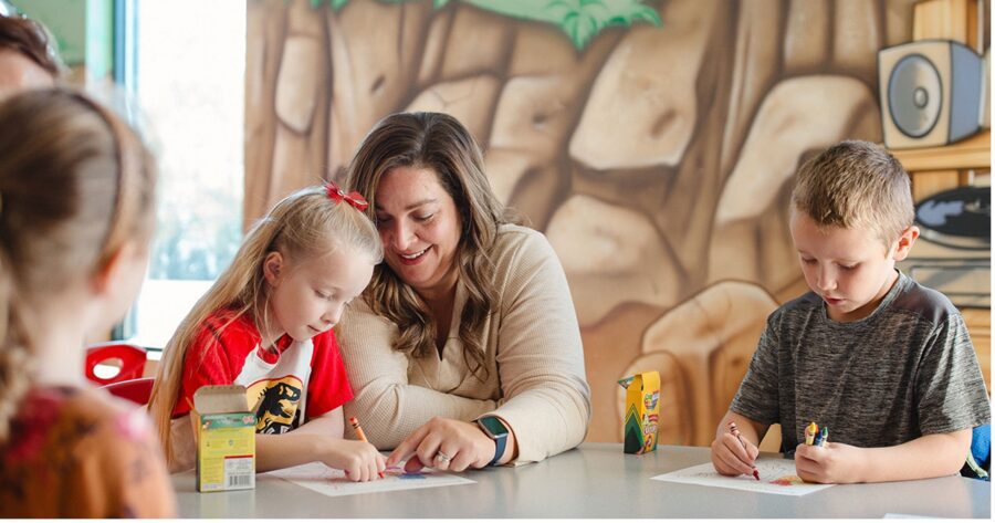 Homeschool mom helping children with schoolwork